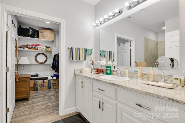 202 Ivy Ct, Morganton, NC 28655 - full bathroom featuring vanity, wood finished floors, a walk in shower, and baseboards