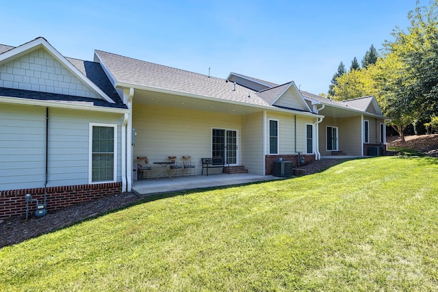 rear view of property with central AC, a yard, and a patio area