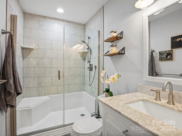 bathroom featuring vanity, toilet, and walk in shower