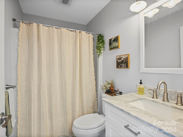 bathroom with vanity, toilet, and a shower with shower curtain