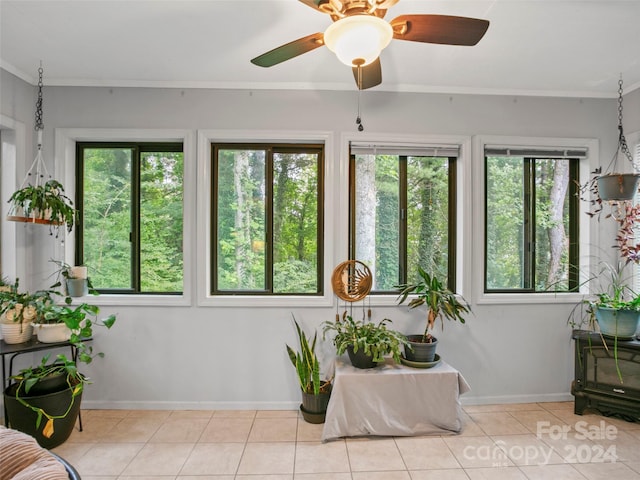 sunroom with a healthy amount of sunlight and ceiling fan