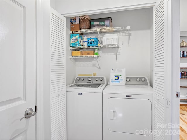 washroom featuring light hardwood / wood-style flooring and separate washer and dryer