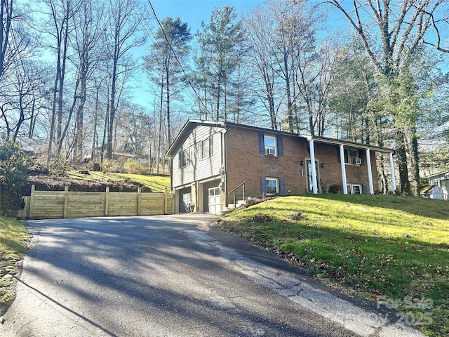 view of home's exterior with a yard and a garage