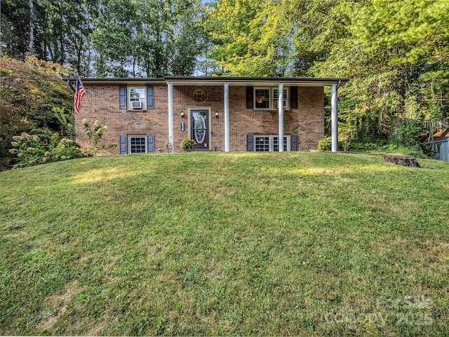 raised ranch featuring a front lawn and cooling unit