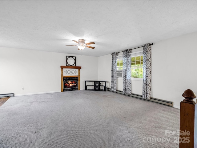 unfurnished living room featuring ceiling fan, baseboard heating, carpet floors, a textured ceiling, and a tiled fireplace