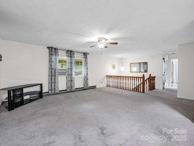 empty room with ceiling fan, carpet, a textured ceiling, and a baseboard heating unit