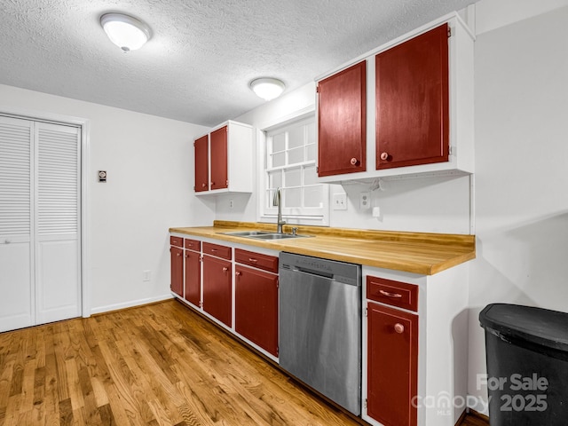 kitchen with dishwasher, light wood-type flooring, a textured ceiling, and sink