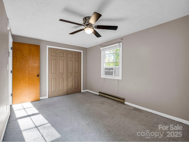 unfurnished bedroom with ceiling fan, a closet, carpet, and a baseboard radiator