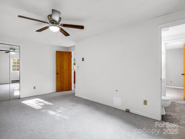 unfurnished bedroom with carpet floors, a closet, ceiling fan, and connected bathroom