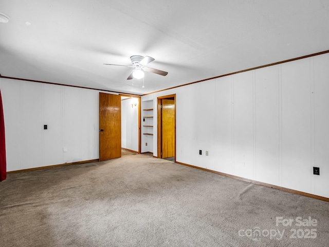 unfurnished room with crown molding, ceiling fan, and light colored carpet