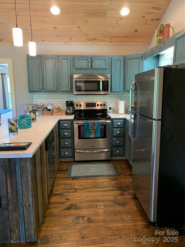 kitchen featuring appliances with stainless steel finishes, dark hardwood / wood-style floors, pendant lighting, decorative backsplash, and wooden ceiling