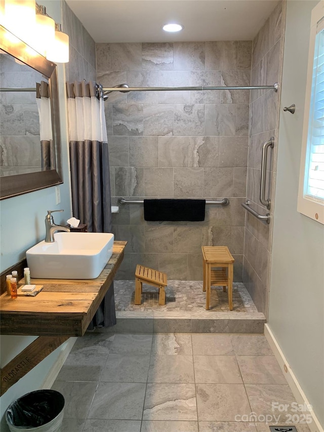 bathroom featuring sink and a shower with shower curtain