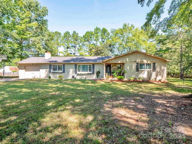 view of front of home featuring a garage and a front lawn