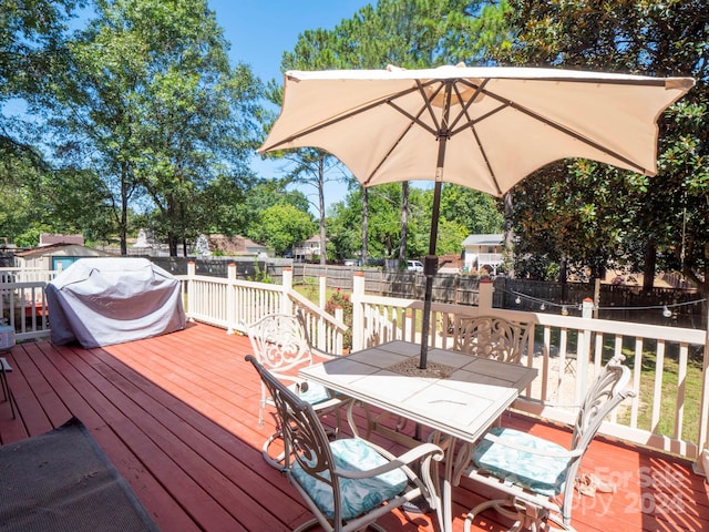 wooden deck with a grill