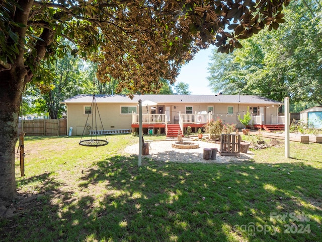 rear view of house featuring a yard and a wooden deck