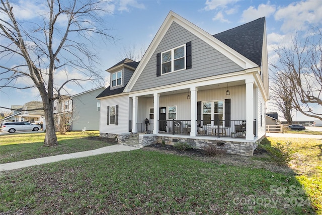 view of front of property with a front yard and a porch