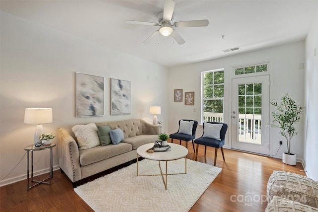 living room with ceiling fan and hardwood / wood-style flooring