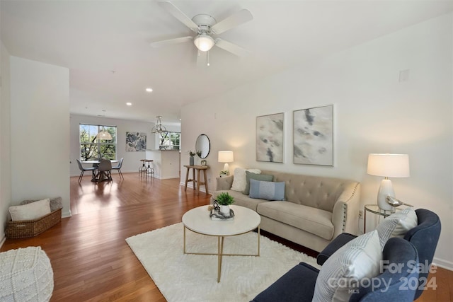 living room with ceiling fan and dark hardwood / wood-style floors