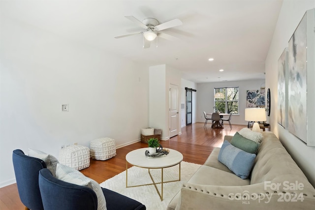 living room with wood-type flooring and ceiling fan