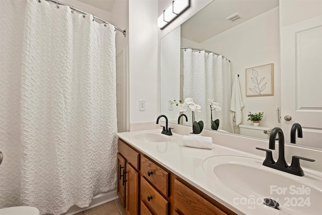 bathroom featuring vanity, toilet, a shower with shower curtain, and tile patterned flooring