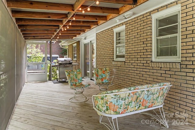 wooden terrace with area for grilling