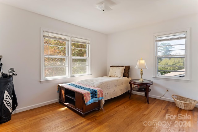 bedroom featuring light wood-type flooring and multiple windows