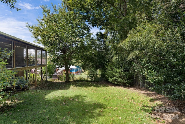 view of yard featuring a sunroom