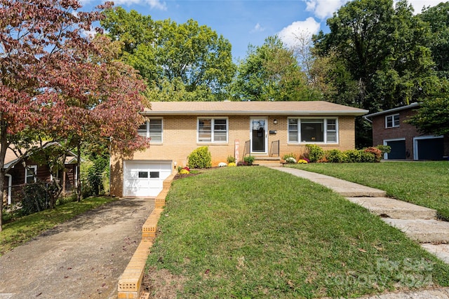 view of front of house with a garage and a front lawn