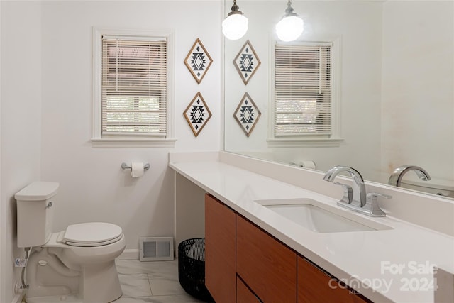 bathroom featuring vanity and toilet