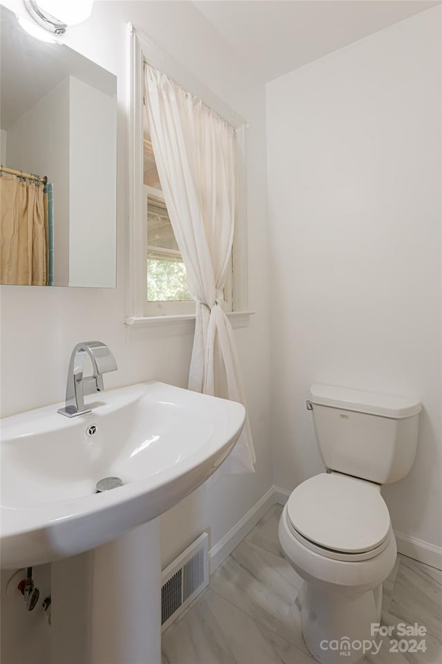 bathroom with sink and toilet