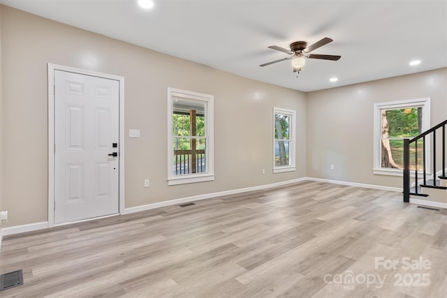 interior space with light hardwood / wood-style flooring and ceiling fan