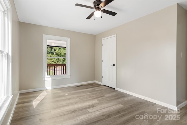 spare room with light hardwood / wood-style floors and ceiling fan