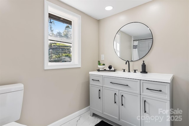 bathroom featuring vanity and toilet