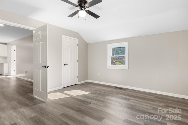 unfurnished room featuring hardwood / wood-style flooring, ceiling fan, and lofted ceiling