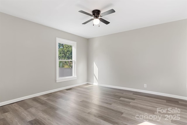 empty room with ceiling fan and hardwood / wood-style floors