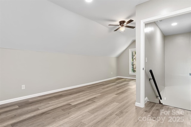 bonus room with ceiling fan, light hardwood / wood-style flooring, and vaulted ceiling