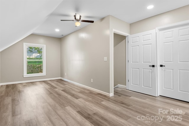 additional living space with ceiling fan, light hardwood / wood-style flooring, and lofted ceiling