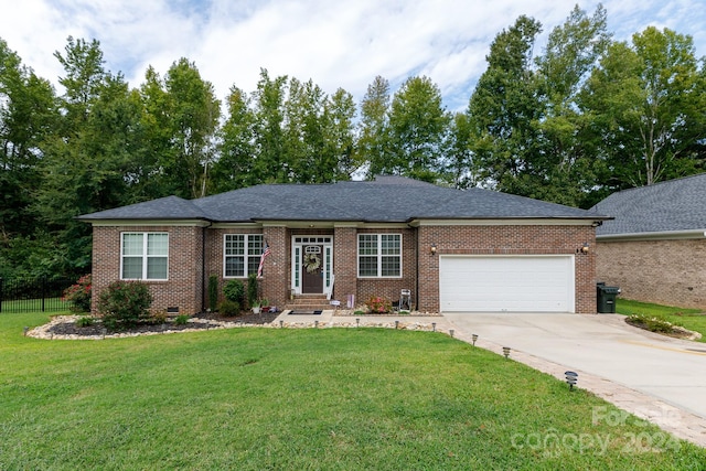 ranch-style home with a garage and a front yard