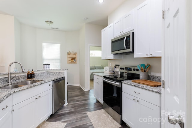 kitchen with white cabinets, appliances with stainless steel finishes, and sink