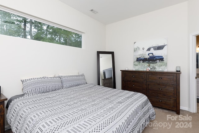 bedroom featuring light carpet