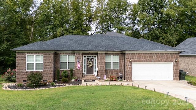 ranch-style house with a garage and a front lawn