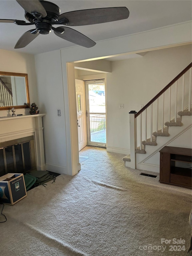 carpeted living room featuring ceiling fan