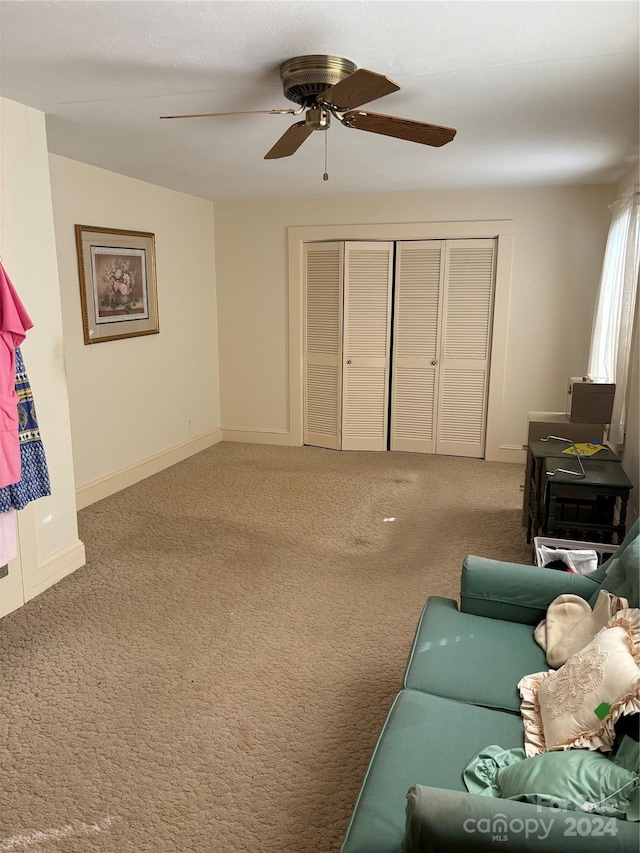 living room featuring carpet floors and ceiling fan