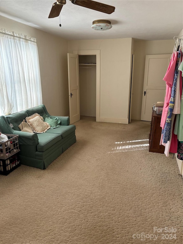 interior space with light carpet and ceiling fan