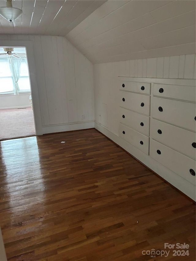 additional living space with dark hardwood / wood-style floors and vaulted ceiling