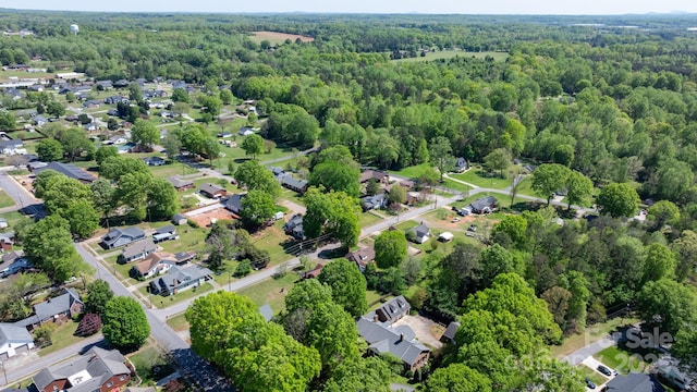 bird's eye view featuring a view of trees and a residential view