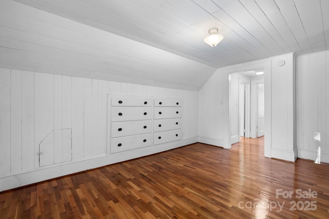 additional living space with lofted ceiling, wood finished floors, wood walls, and wood ceiling