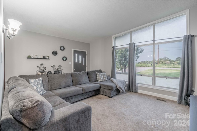 living room with light carpet and a textured ceiling