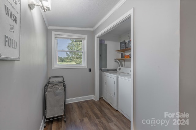 laundry area with ornamental molding, dark hardwood / wood-style flooring, washing machine and clothes dryer, and a textured ceiling