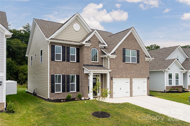 view of front of property with a garage and a front lawn